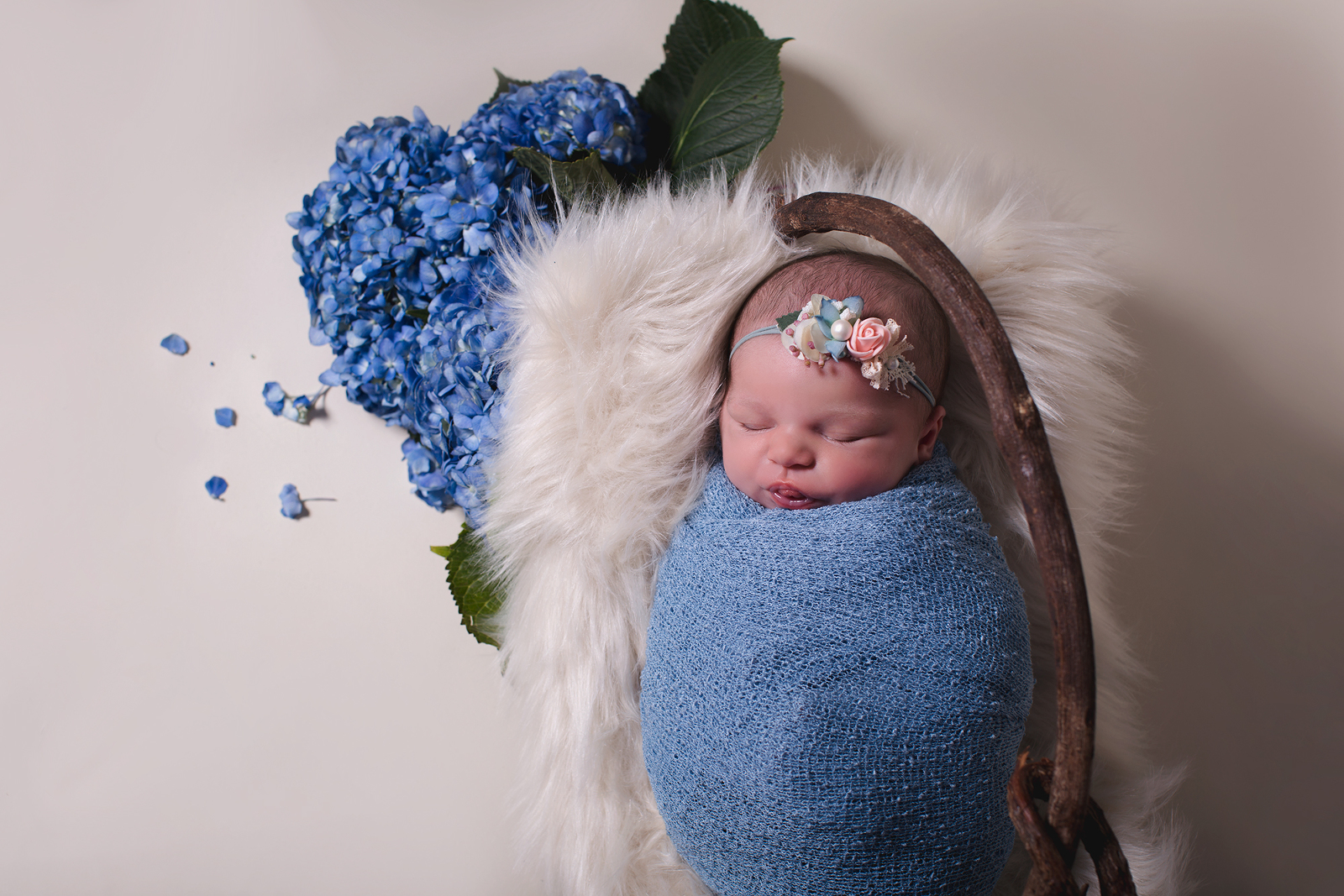 newborn girl wrapped in blue